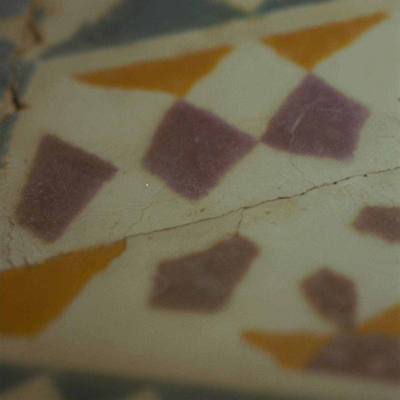 A hand-glazed Islamic geometric tile, indigo and saffron.